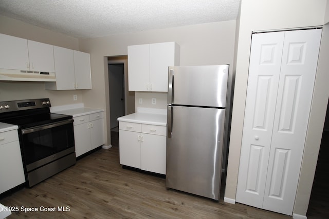 kitchen with white cabinets, a textured ceiling, dark hardwood / wood-style floors, and appliances with stainless steel finishes