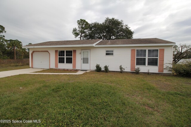 single story home featuring a garage and a front lawn