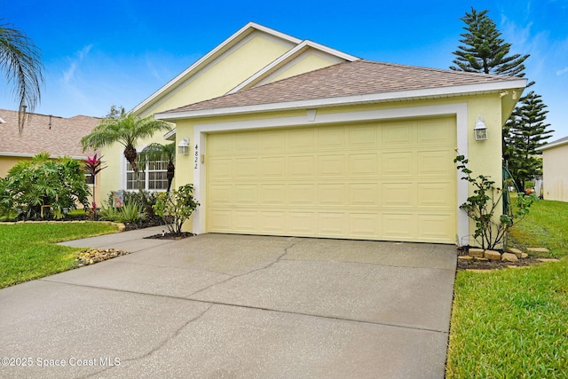 view of front of house with a garage and a front lawn