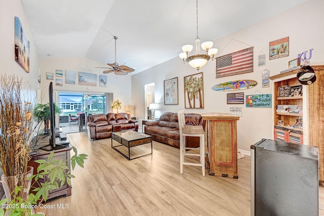 living room featuring ceiling fan with notable chandelier, light hardwood / wood-style flooring, and lofted ceiling