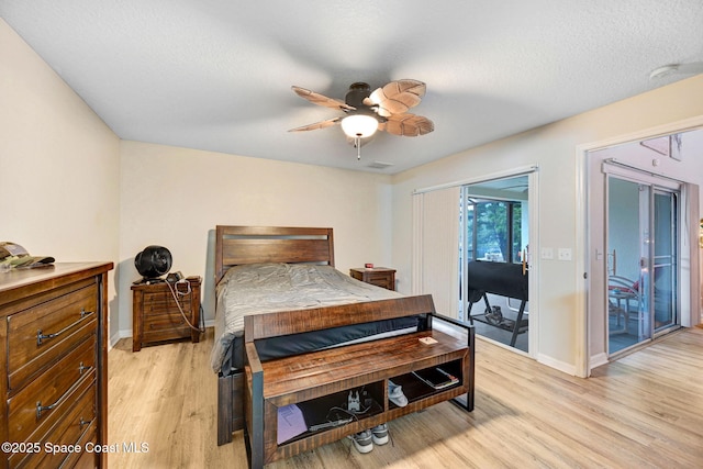 bedroom with access to exterior, ceiling fan, light hardwood / wood-style floors, and a textured ceiling