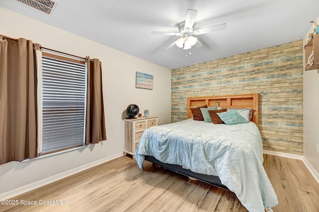 bedroom with ceiling fan and light hardwood / wood-style flooring