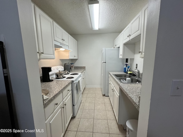 kitchen featuring light tile patterned floors, white cabinetry, white appliances, a textured ceiling, and sink