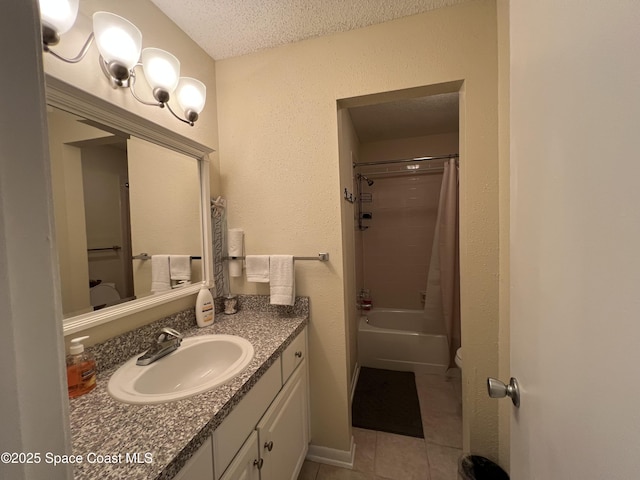 full bathroom featuring a textured ceiling, tile patterned floors, vanity, toilet, and shower / bath combo with shower curtain