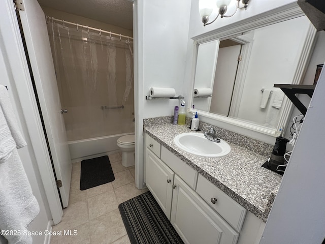 full bathroom featuring toilet, vanity, tile patterned floors, and shower / bath combo with shower curtain