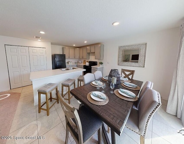 dining area with sink and light tile patterned floors