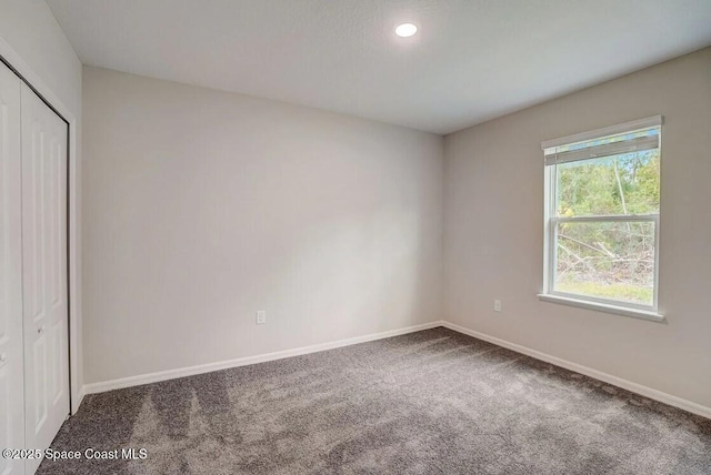 unfurnished bedroom with a closet and carpet flooring