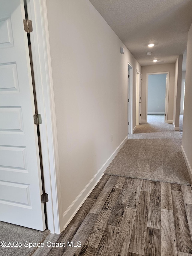 3317 Fitzpatrick Ave SW, Palm Bay, FL 32908 - hall with baseboards, wood finished floors, carpet, and a textured ceiling