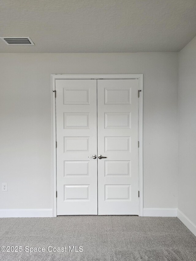 3317 Fitzpatrick Ave SW, Palm Bay, FL 32908 - unfurnished bedroom featuring carpet floors, baseboards, and a closet