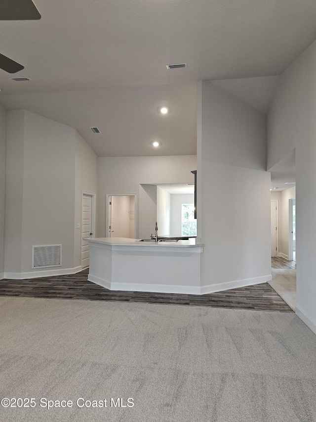 3317 Fitzpatrick Ave SW, Palm Bay, FL 32908 - unfurnished living room featuring carpet floors, baseboards, a ceiling fan, a sink, and recessed lighting