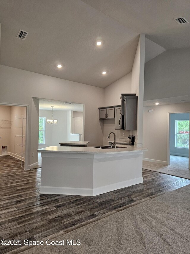 3317 Fitzpatrick Ave SW, Palm Bay, FL 32908 - kitchen with baseboards, dark wood-style floors, a sink, a chandelier, and gray cabinets