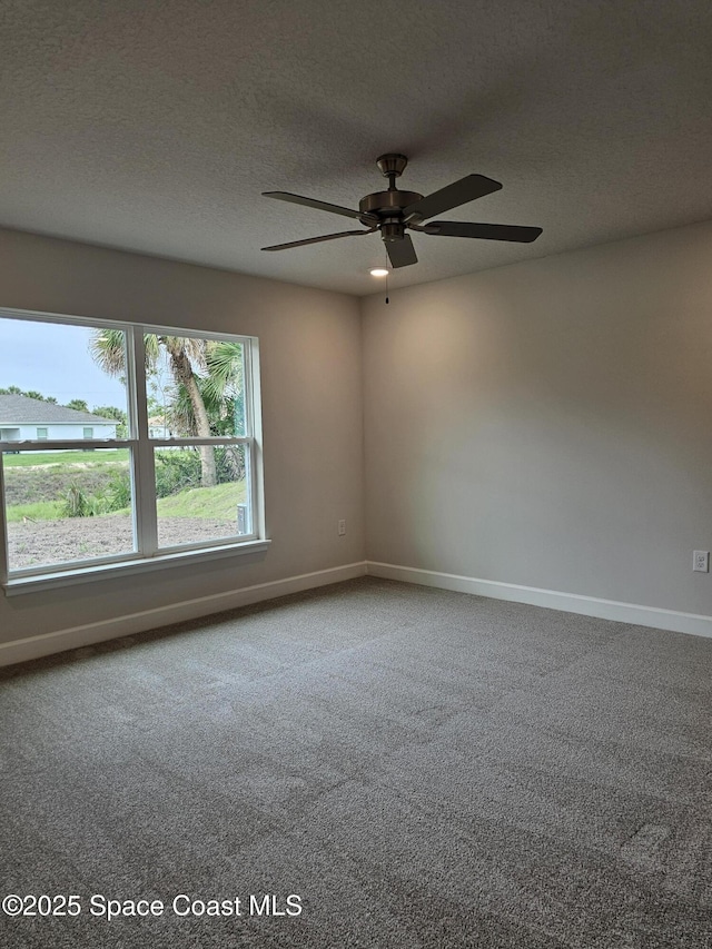 3317 Fitzpatrick Ave SW, Palm Bay, FL 32908 - carpeted empty room with baseboards, a textured ceiling, and ceiling fan