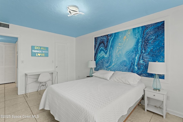 tiled bedroom with a textured ceiling