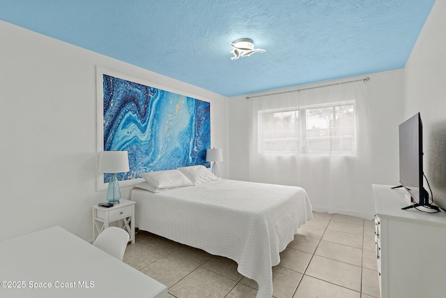 tiled bedroom featuring a textured ceiling