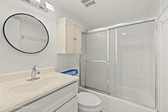 full bathroom with toilet, vanity, and combined bath / shower with glass door