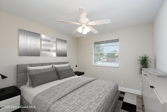 bedroom featuring hardwood / wood-style floors and ceiling fan