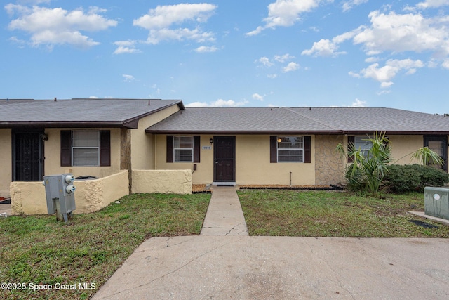 ranch-style home with a front lawn