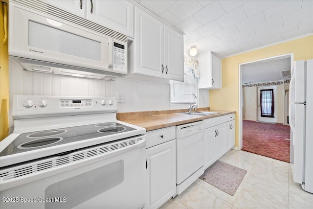 kitchen with sink, white cabinetry, crown molding, light colored carpet, and white appliances