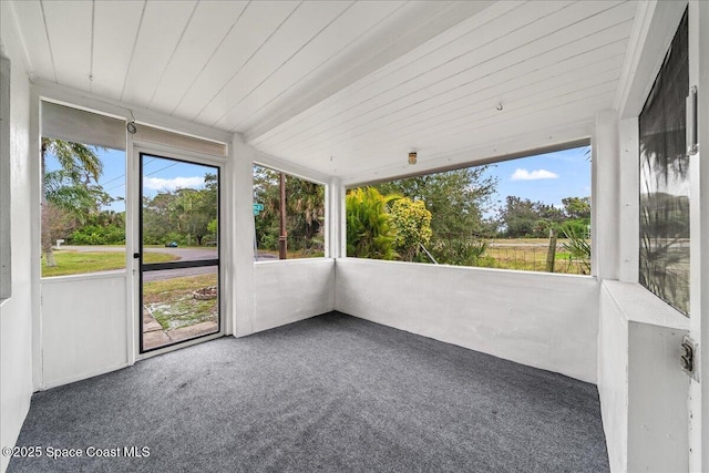 unfurnished sunroom with plenty of natural light and wood ceiling