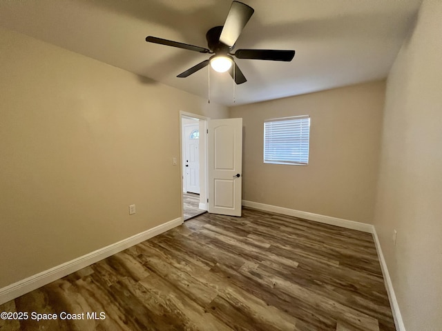 spare room with hardwood / wood-style floors and ceiling fan