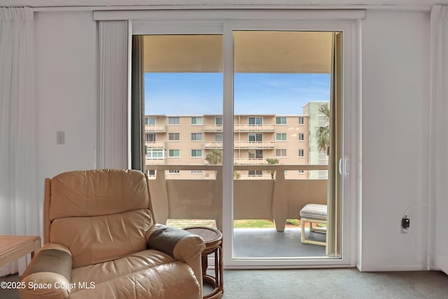 living area featuring a wealth of natural light and carpet flooring