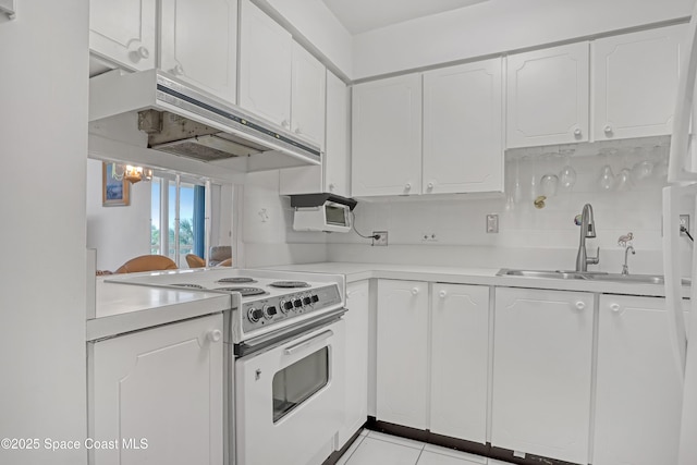 kitchen with sink, light tile patterned floors, white range with electric stovetop, tasteful backsplash, and white cabinets