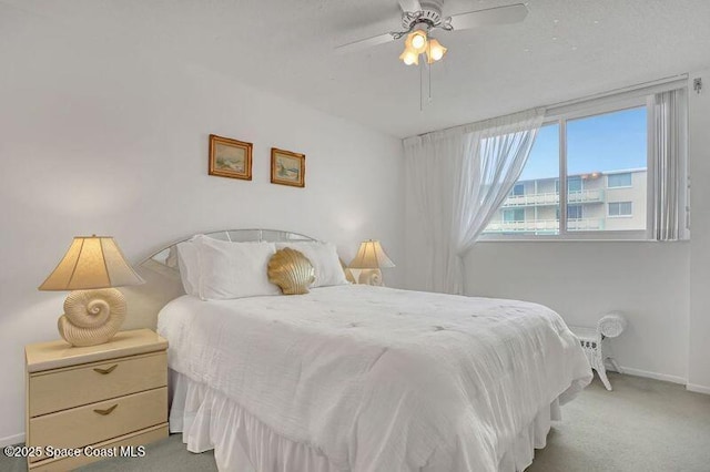 carpeted bedroom featuring a ceiling fan and baseboards