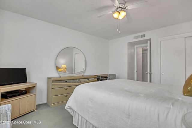 carpeted bedroom featuring a closet and ceiling fan