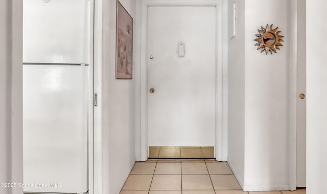 corridor featuring light tile patterned floors