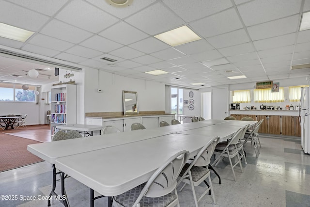 interior space featuring a paneled ceiling, visible vents, and light floors