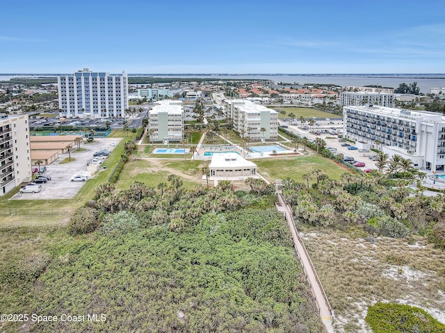 drone / aerial view featuring a water view and a city view