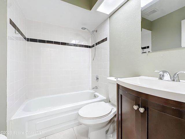 full bathroom featuring vanity, tile patterned floors, toilet, and washtub / shower combination