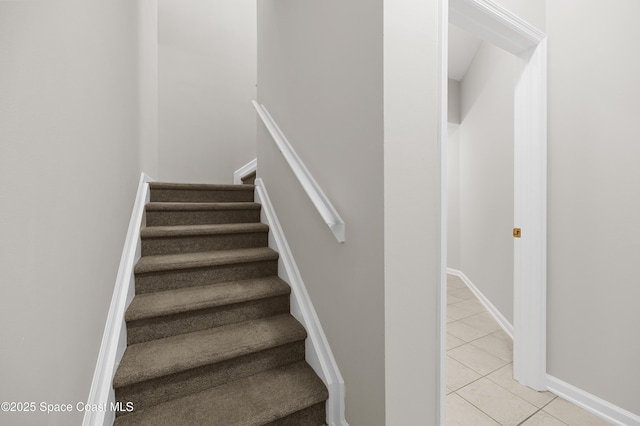 staircase featuring tile patterned floors