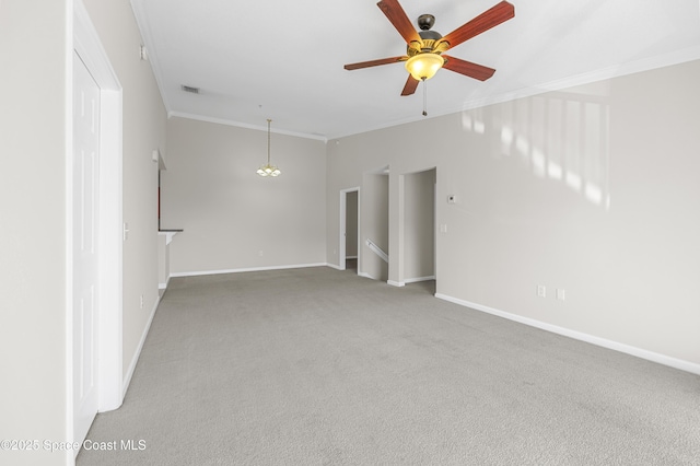 carpeted empty room with crown molding and ceiling fan