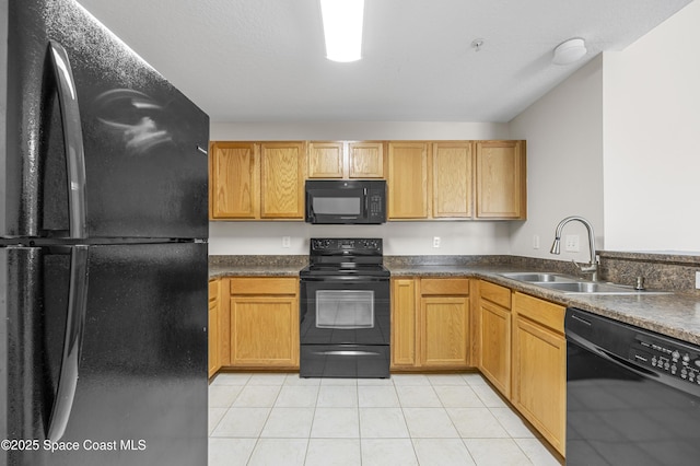 kitchen with sink, black appliances, and light tile patterned flooring