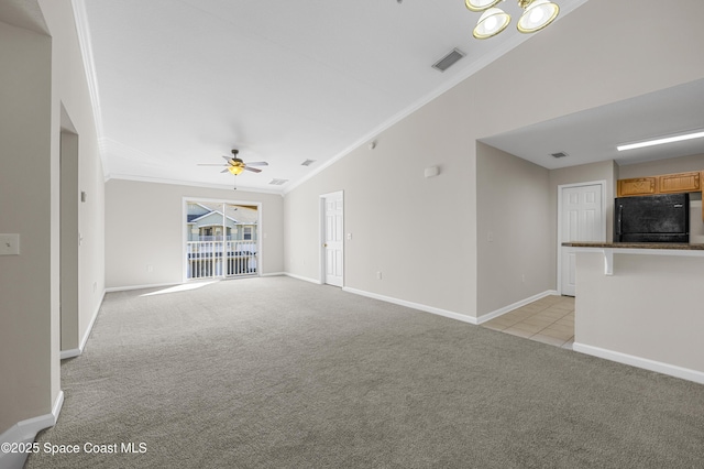 unfurnished living room featuring lofted ceiling, light colored carpet, ornamental molding, and ceiling fan