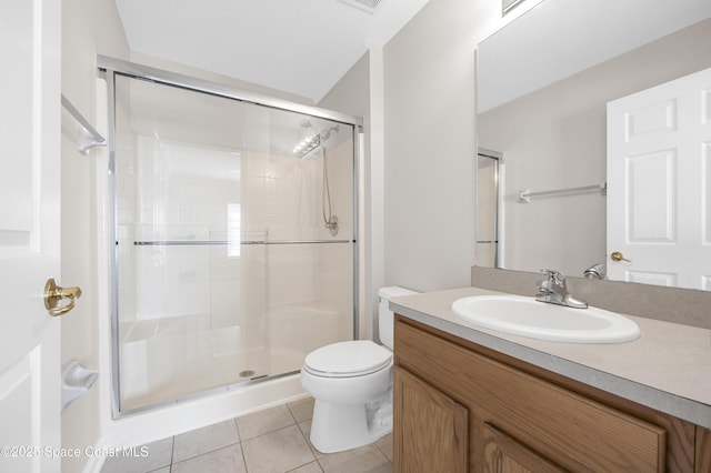 bathroom with tile patterned floors, toilet, an enclosed shower, and vanity