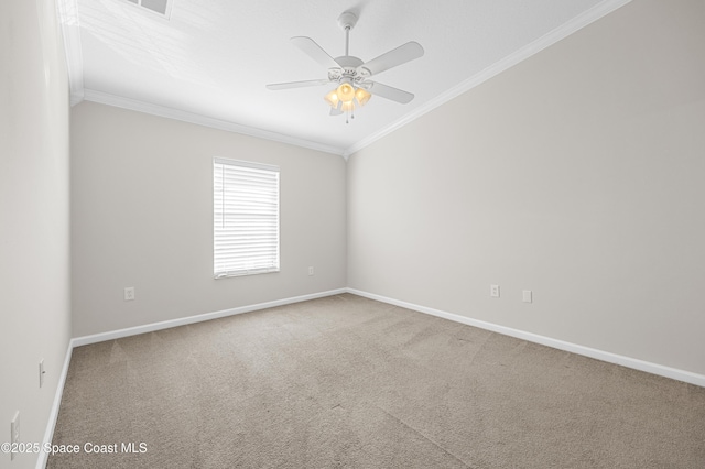 carpeted spare room with ceiling fan and ornamental molding