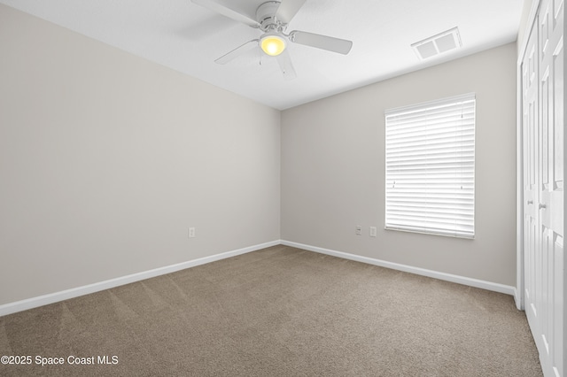 spare room with carpet floors and ceiling fan