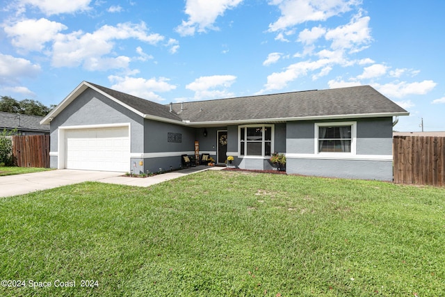 ranch-style house featuring a front lawn and a garage