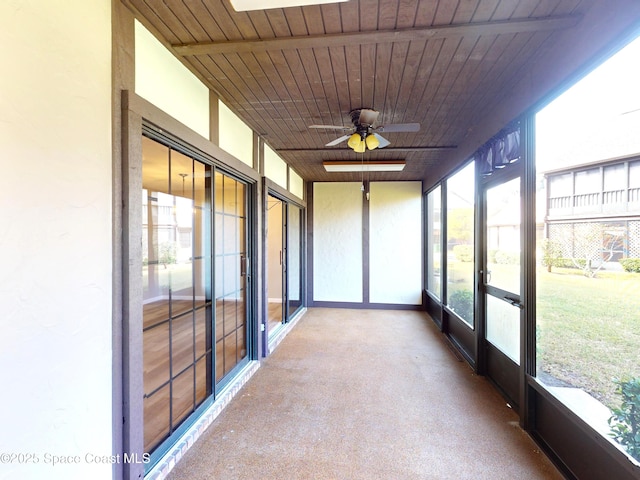 unfurnished sunroom with ceiling fan and wood ceiling