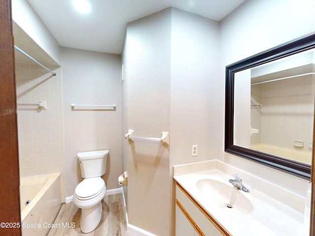 bathroom featuring toilet, vanity, and hardwood / wood-style floors