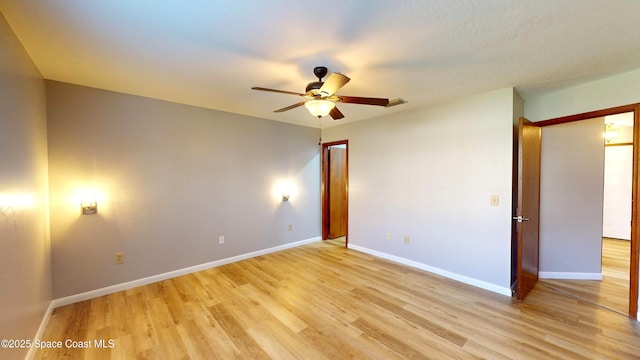 unfurnished room with light wood-type flooring and ceiling fan