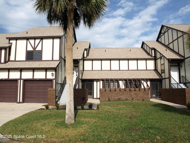 view of front of home featuring a garage and a front yard