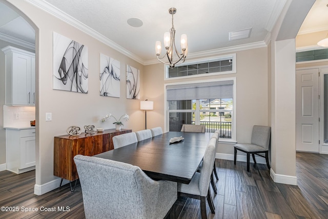 7690 Kerrington Dr, Melbourne, FL 32940 - dining room featuring crown molding, dark hardwood / wood-style floors, an inviting chandelier, and a textured ceiling