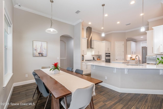 7690 Kerrington Dr, Melbourne, FL 32940 - dining room with crown molding, dark hardwood / wood-style floors, and sink