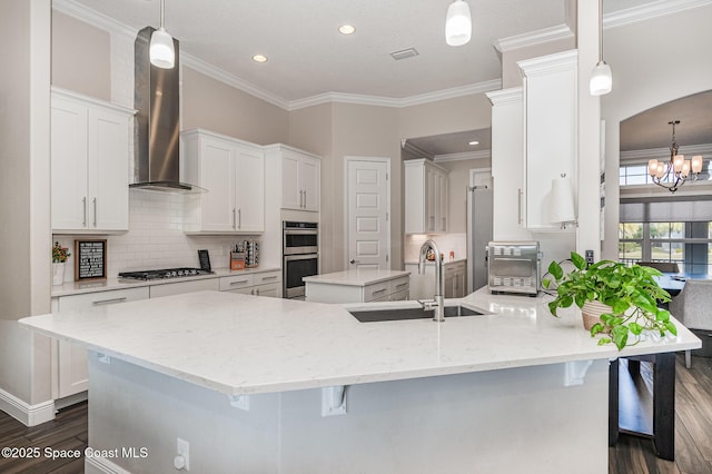 7690 Kerrington Dr, Melbourne, FL 32940 - kitchen with a kitchen island with sink, sink, decorative light fixtures, and wall chimney exhaust hood