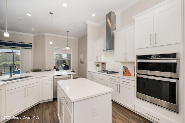 7690 Kerrington Dr, Melbourne, FL 32940 - kitchen with wall chimney exhaust hood, sink, pendant lighting, stainless steel appliances, and white cabinets