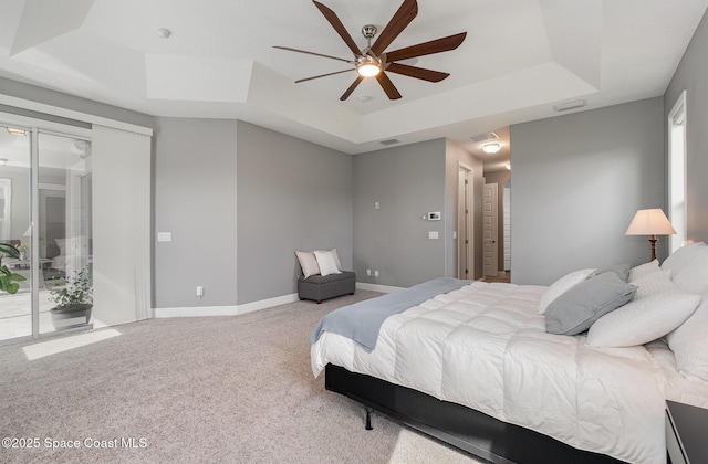 7690 Kerrington Dr, Melbourne, FL 32940 - bedroom featuring access to exterior, a tray ceiling, ceiling fan, and carpet
