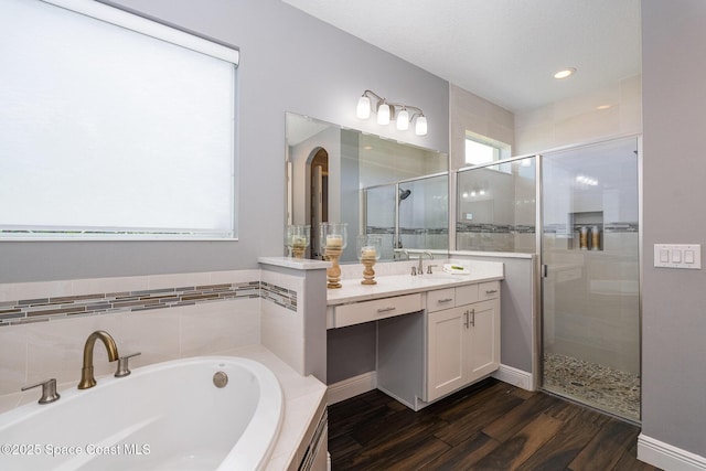 7690 Kerrington Dr, Melbourne, FL 32940 - bathroom featuring plenty of natural light, independent shower and bath, hardwood / wood-style floors, and vanity